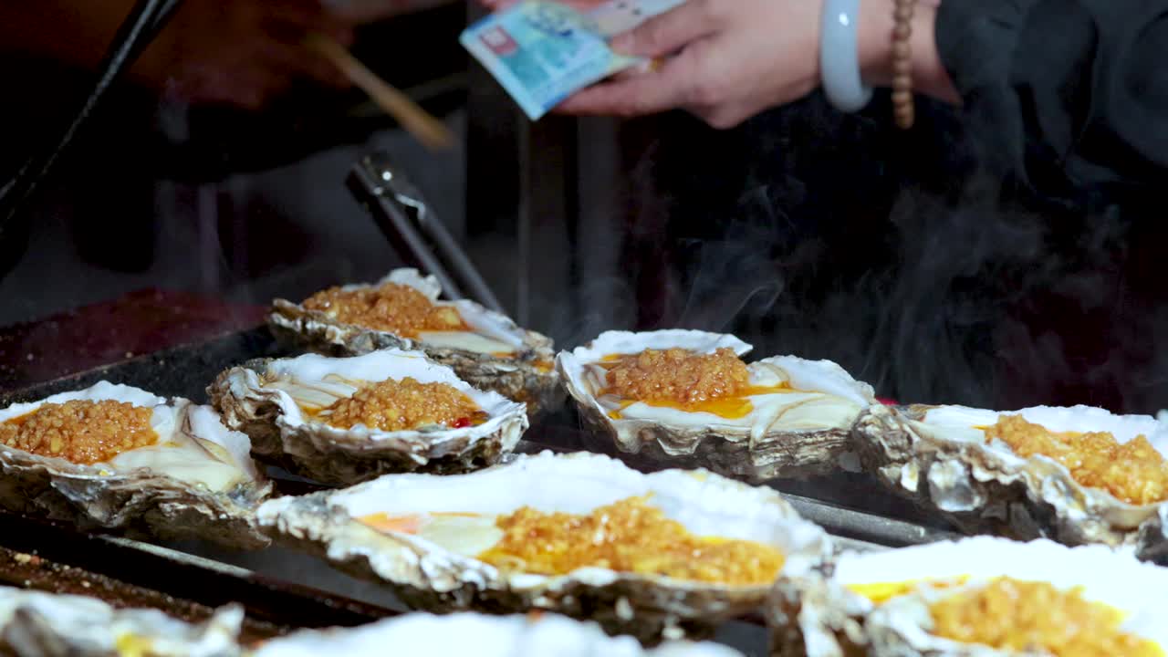 Oysters being grilled and served in Hong Kong