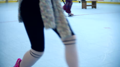 group of girls having fun skating at a roller skate rink with flashing wheels