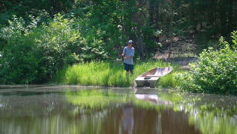 angler throwing bait and hook into calm water from a sunny shoreline