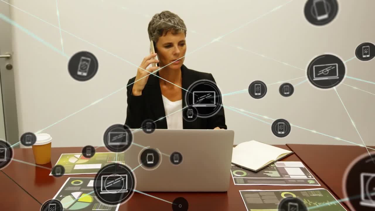Animation of network of digital icons over caucasian businesswoman talking on smartphone at office