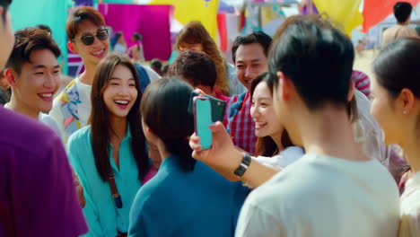group of friends taking a picture at a festival
