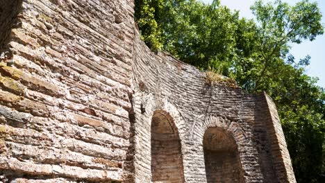 Butrint,-Albania,-view-of-a-wall-with-arched-windows-in-an-ancient-stone-structure