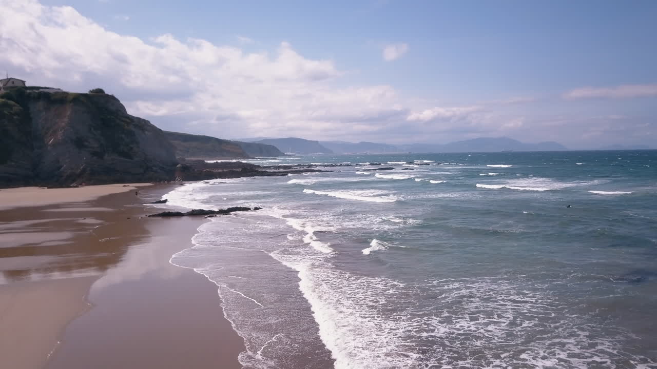 vista suave de drones en la playa de sopelana en el fondo los acantilados del país vasco