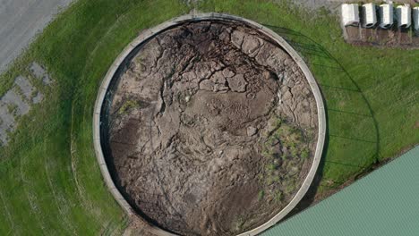 rising aerial of manure pit, slurry in round storage holding tank