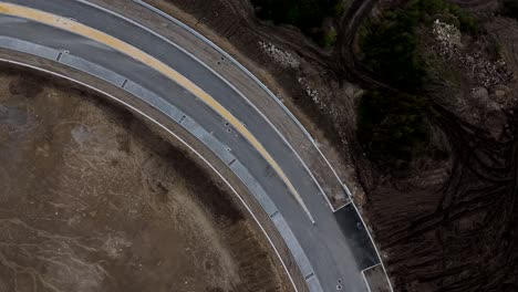 Aerial curved road and construction site with cleared ground in Portugal