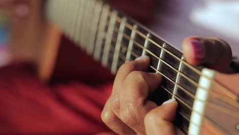 woman hands playing guitar outdoor. - selective focus