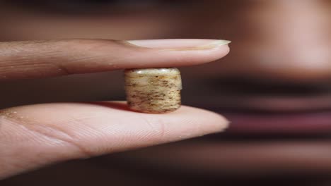 person holding a capsule