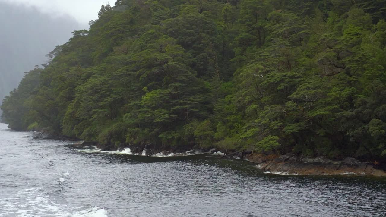 POV from a boat tour sailing around Doubtful sound in The Fiordland National Park, New Zealand. This is a popular boat trip that people can take in New Zealand's South Island