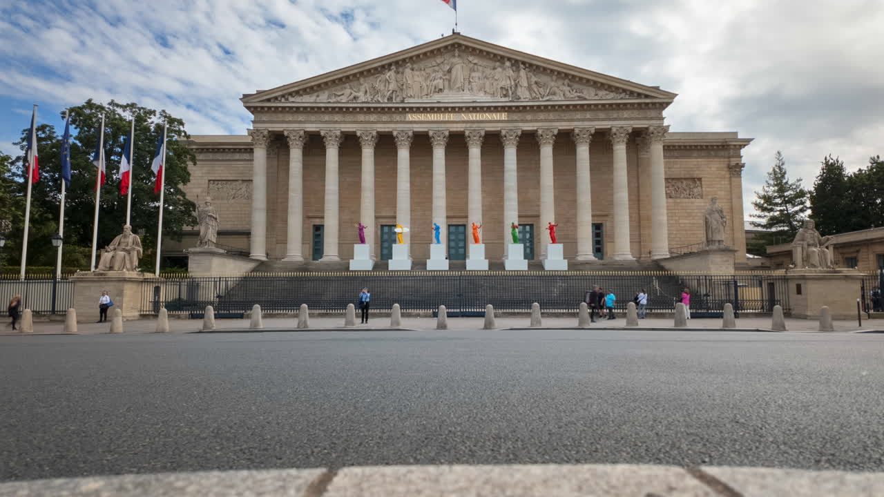 Time lapse of cars moving in front of the Palais Bourbon in daylight, Paris, France