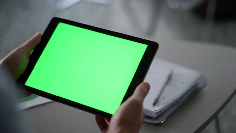 Entrepreneur-hands-holding-tablet-looking-screen-chroma-key-in-workplace-cafe.