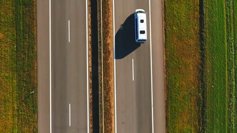 Top-view-car-slowly-driving-along-highway.-Cars-driving-on-suburban-road