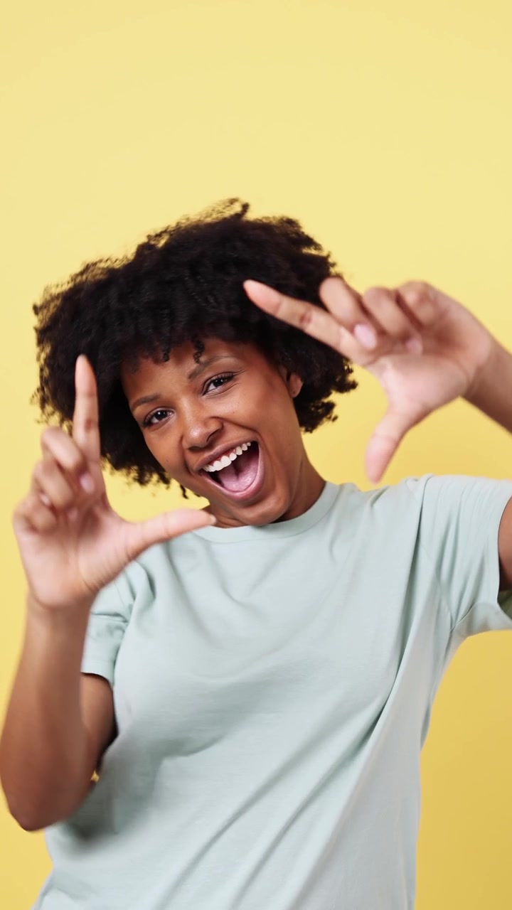 Cheerful Young African American Woman Framing View with Hands