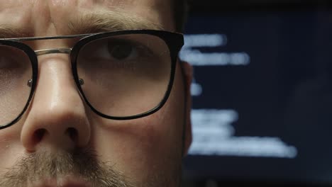 close-up of a man watching as code appears on the screen behind him—symbolizing how ai takes over programming tasks and automates digital work silently in the background