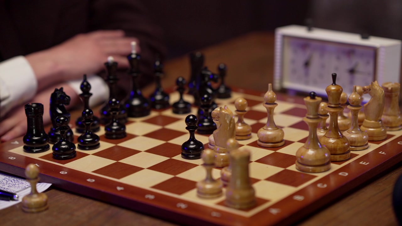 Joueurs d'échecs effectuant des coups sur un échiquier avec une pendule.