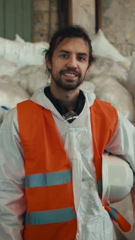 worker in protective gear at recycling facility