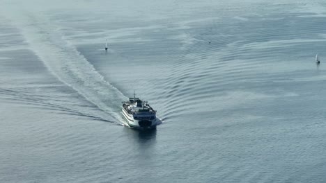 a washington state ferry pulling into seattle's downtown port to load up passengers