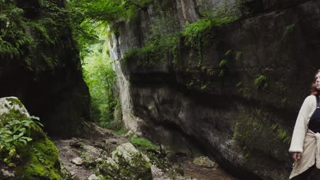 woman exploring a rocky canyon in a forest