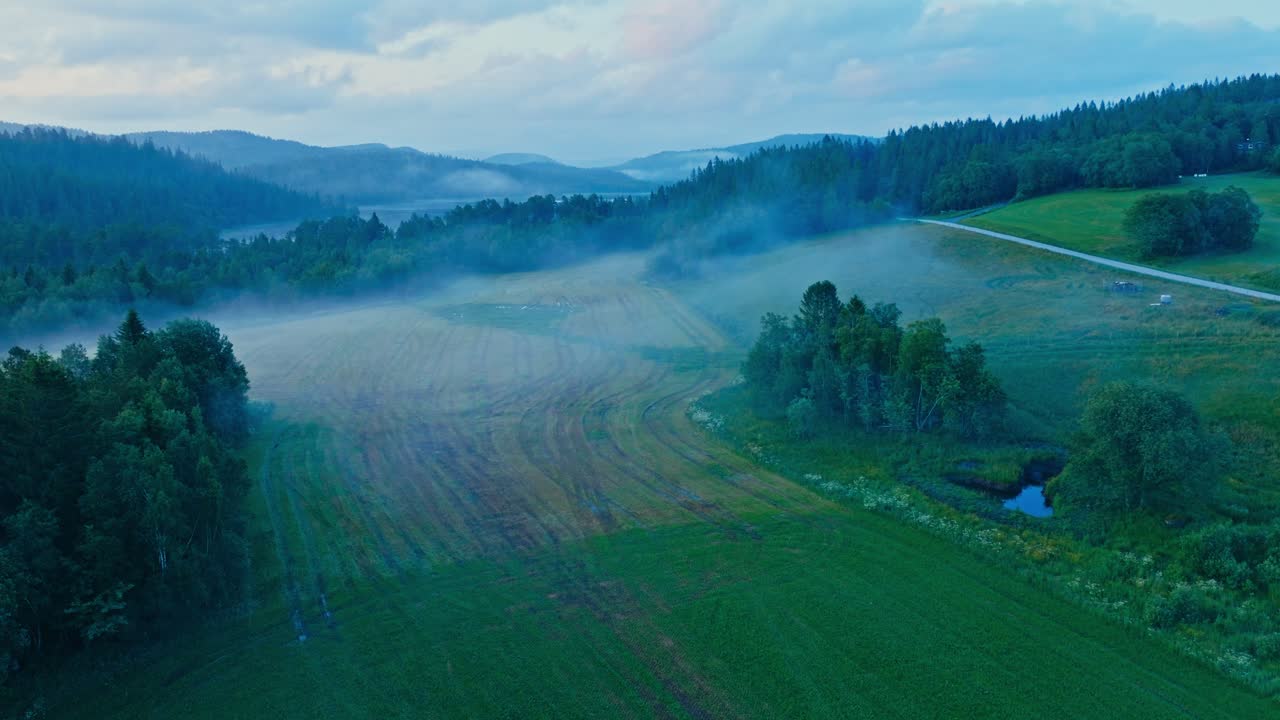 Green Fields With Fog In Rural Norway - Drone Shot