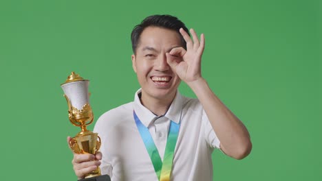 man celebrating victory with trophy