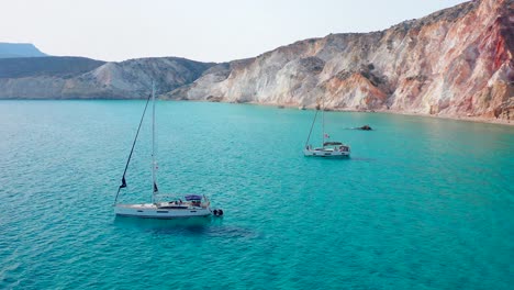 yachts in fyriplaka beach aerial close up drone shot of greek milos island