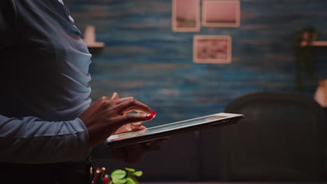 close up of african employee sending messages using tablet