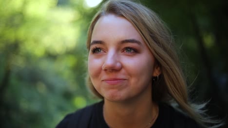 slow motion shot of a beautiful blonde female sitting in the mountains-1