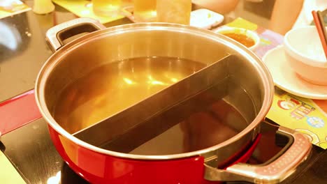 hand removes lid from steaming hot pot