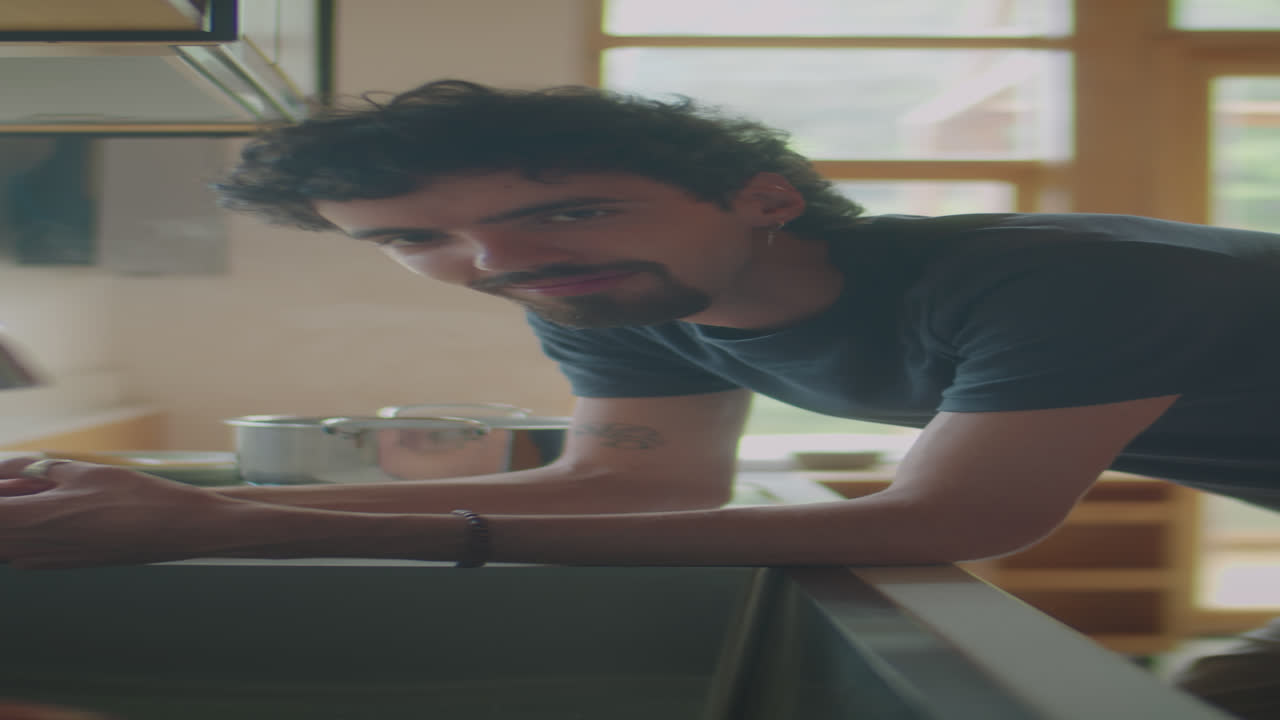 Portrait of Man Leaning on Kitchen Counter