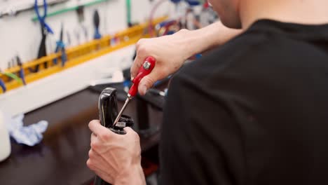 anonymous mechanic cleaning bicycle fork with air blow gun