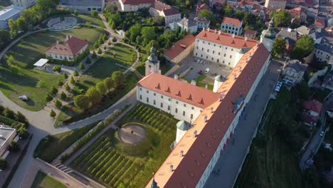 fantastic panorama in day light of kutna hora in czech republic, with a large building, a park and pedestrians