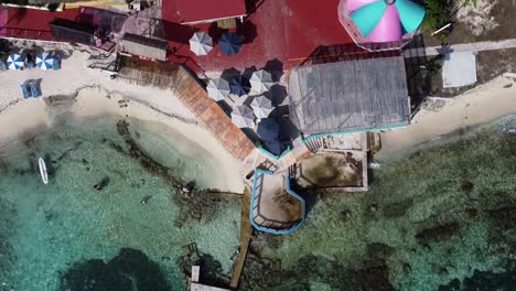 Aerial-drone-bird's-eye-view-of-the-beach-of-Isla-Mujeres-island-in-Quintana-Roo-Mexico-on-a-bright-sunny-day