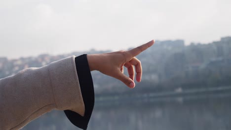 person pointing at cityscape