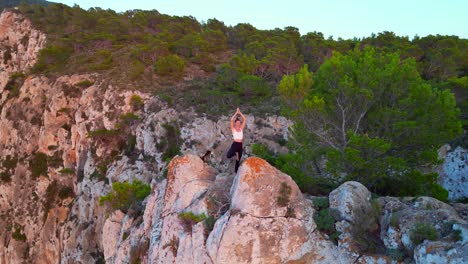 stunning aerial top view flight ibiza cliff yoga tree pose model girl sunset evening