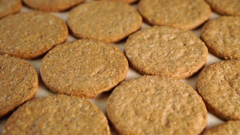 neatly folded oatmeal cookies rotate on a wooden board