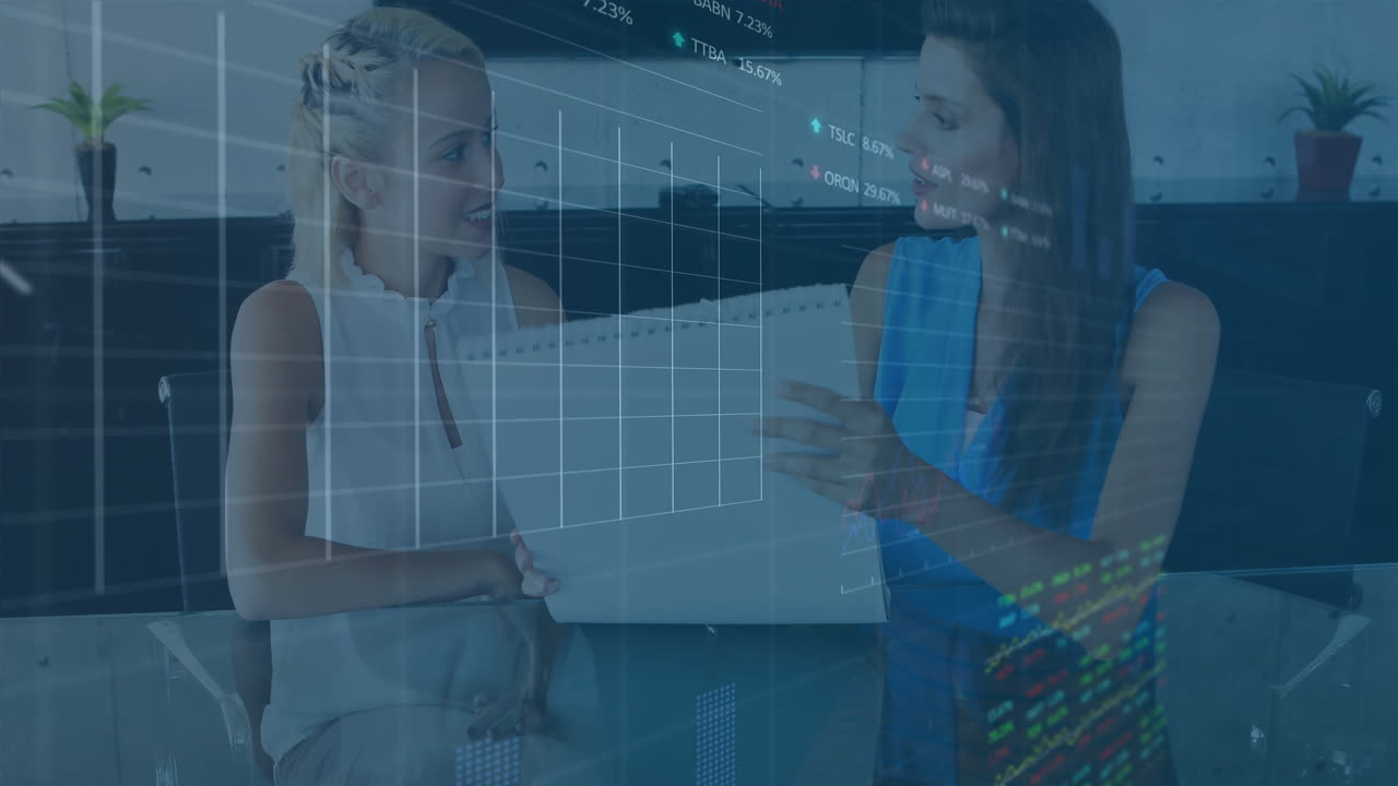 Female professionals reviewing reports on office table, with animated financial charts floating