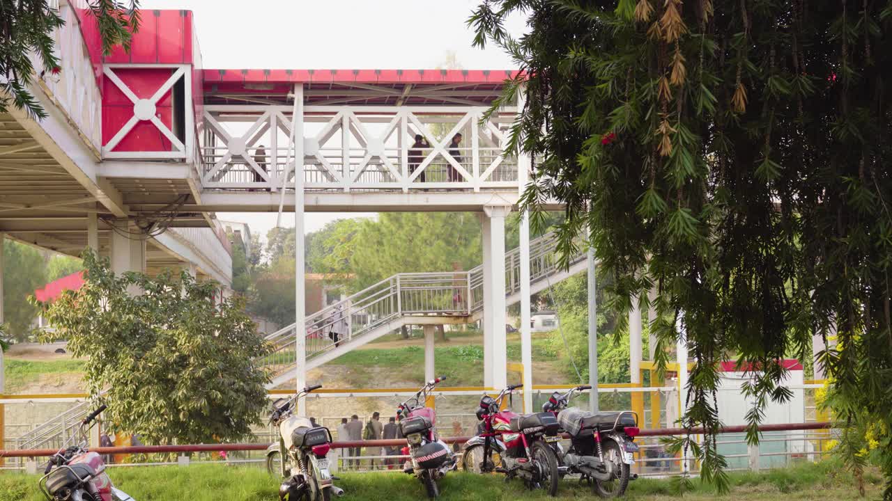A city metro bus station with passengers walking along its pathway to board the bus showcases a scenic infrastructure.