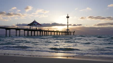 brighton beach jetty, waves and reflection at sunset, adelaide, south australia