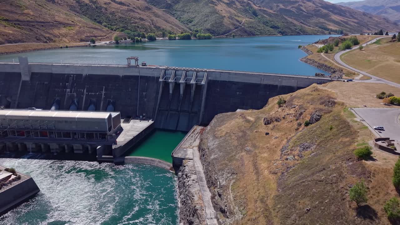 Clyde Dam in New Zealand with serene lake and concrete structure
