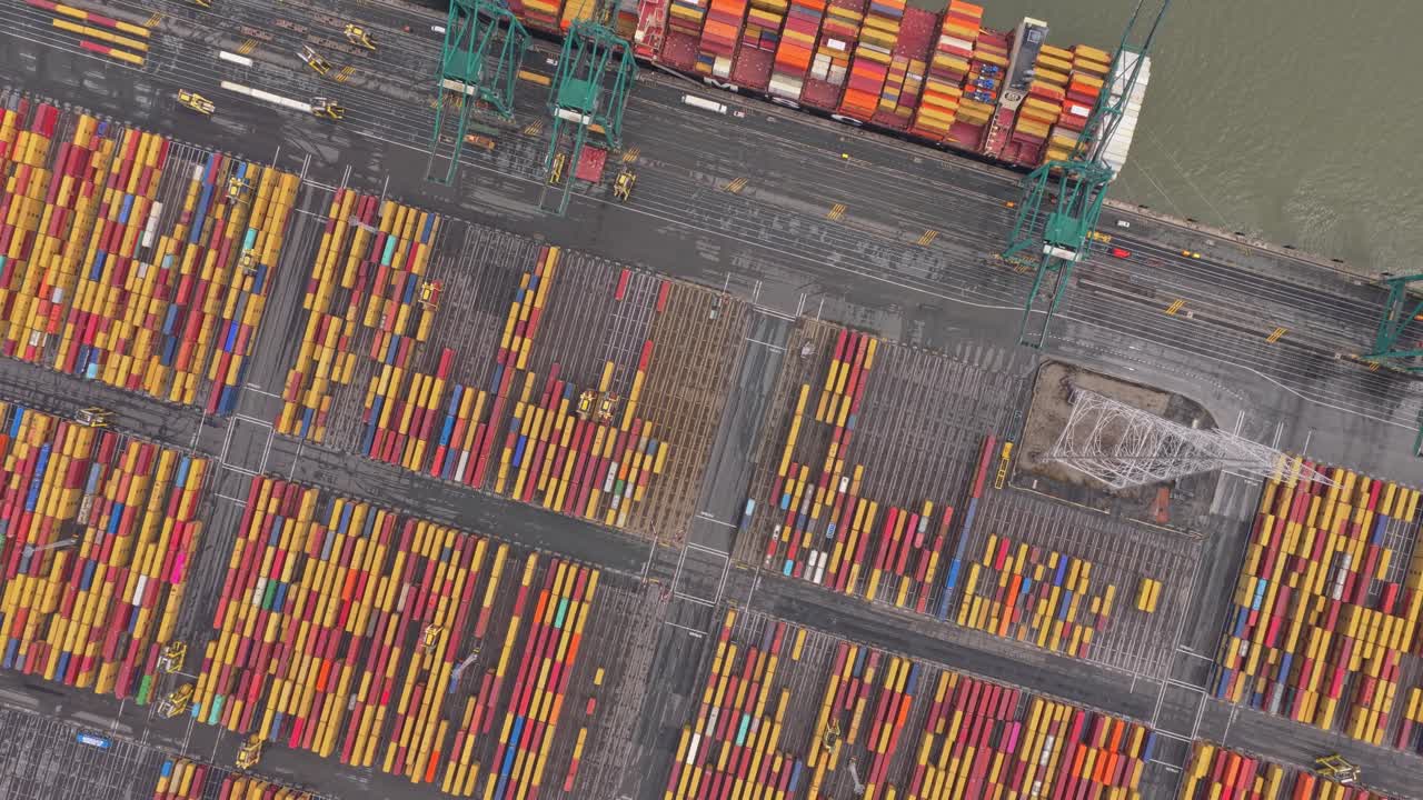 Top down aerial of Antwerp cargo port with ships, cranes and trucks, Belgium