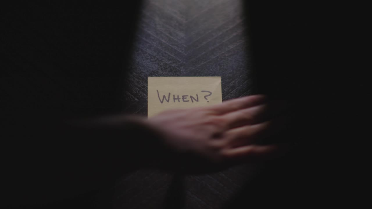 A sticky note reading "When" dramatically placed on a table