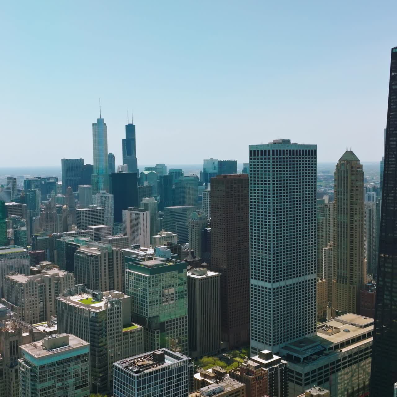 Densely built-up urban territory. Multi-storied buildings and luxurious skyscrapers at the backdrop of blue clear sky
