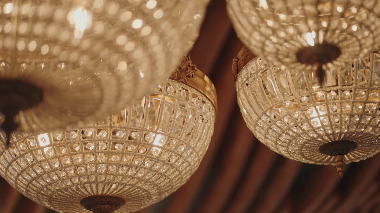 luxury crystal chandeliers glow at wedding reception venue