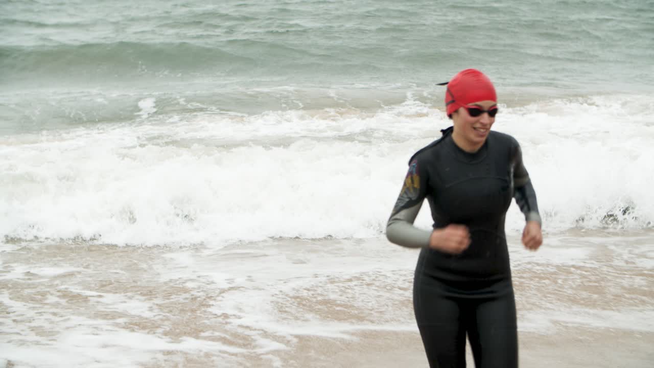 Happy sportswoman in sea waves