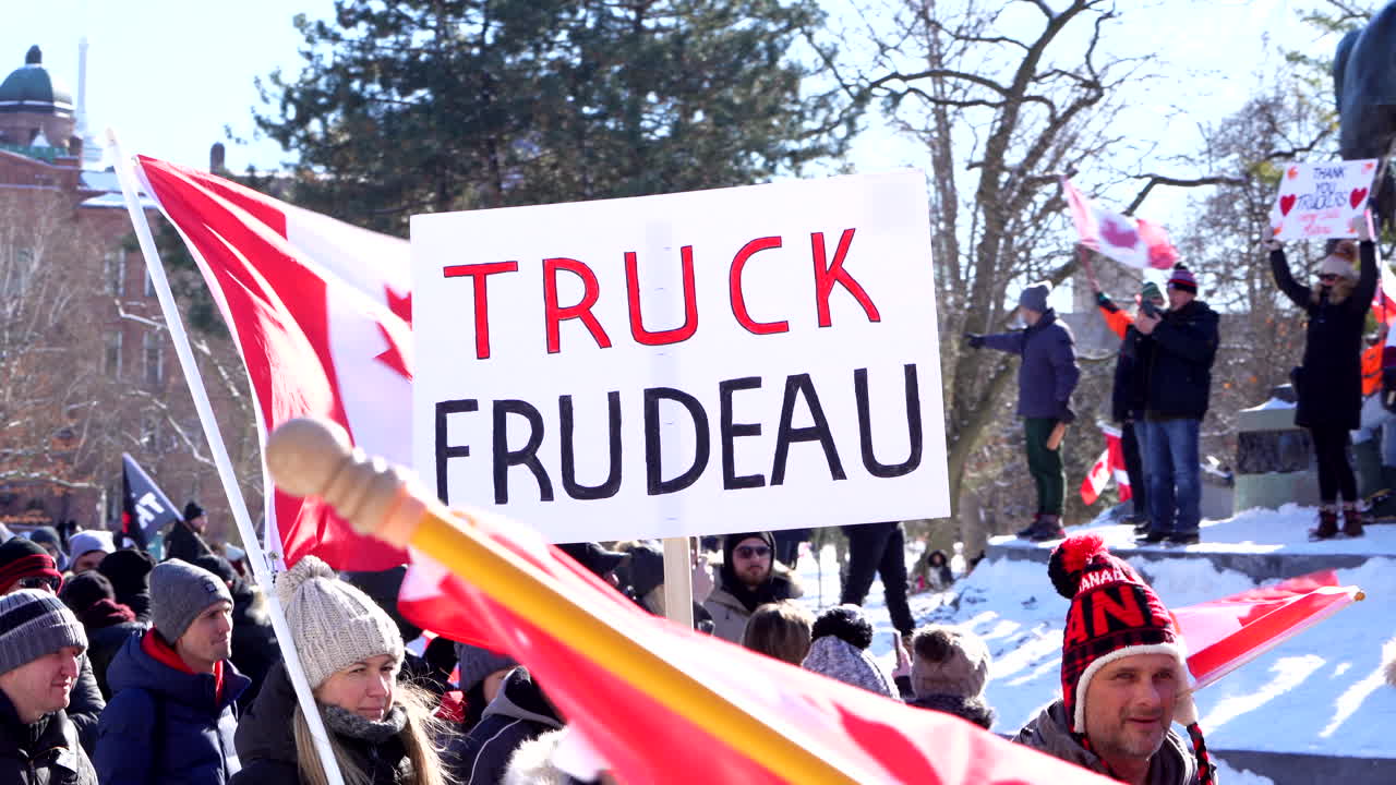Crowds Protesting with anti Covid Mandate Posters in Toronto.