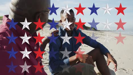 Animation-of-stars-in-usa-flag-colours-over-african-american-men-talking-on-beach