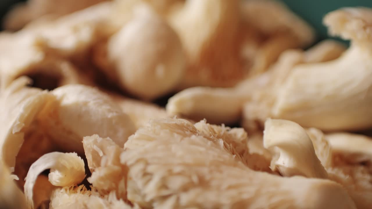 Woman hand holds a basket of lung oyster mushrooms. Close up of supermarket farmer food.
