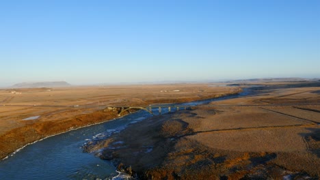 aerial view of frozen urriðafoss waterfall in iceland with wild river