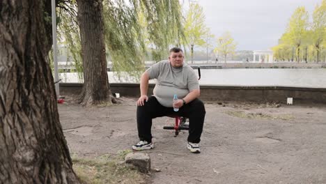 one overweight man in the park exercising male large caucasian man working outdoors weight loss one overweight man in the park exercising male large caucasian man working outdoors the concept of motivational discipline weight loss