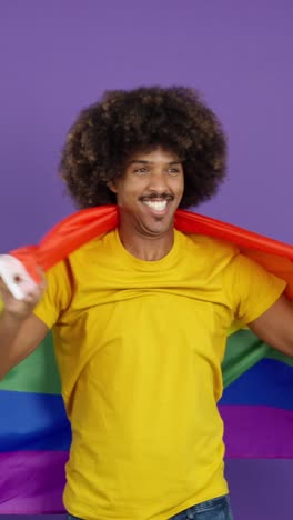 person draped in a rainbow flag smiling