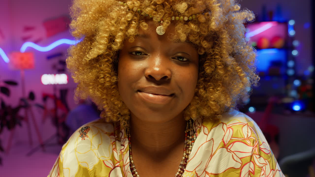 Woman with Curly Hair and Ethnic Jewelry in a Night Room